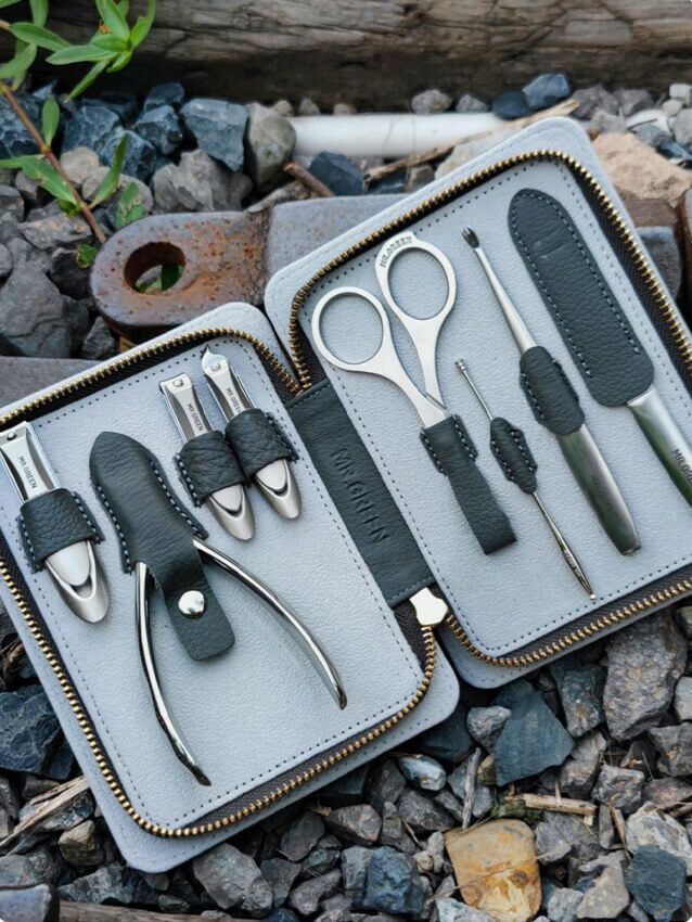 MR.GREEN manicure set in Morandi grey full-grain leather case, open to show stainless steel clippers, nipper, scissors, tweezers and nail file — premium grooming kit