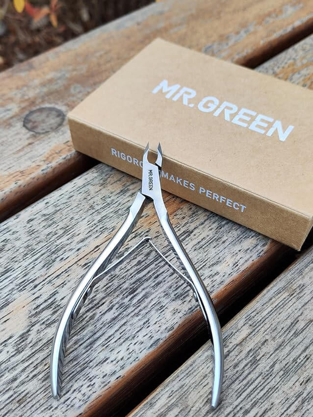 MR.GREEN stainless steel cuticle nipper — professional dead skin remover with ergonomic spring handle, shown beside branded box